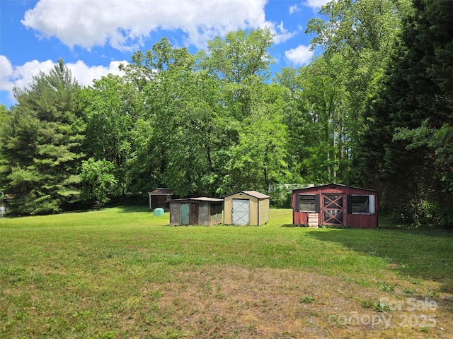 view of grassy yard with a storage unit and an outdoor structure