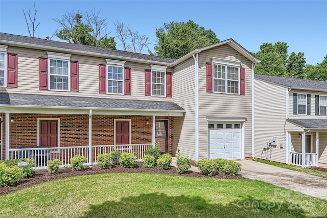 6335 Ziegler Ln, Charlotte, NC 28269 - view of front facade with a garage, concrete driveway, a front lawn, and a porch