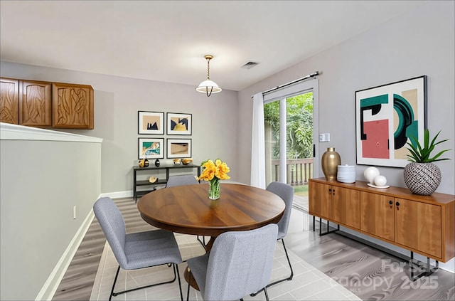 6335 Ziegler Ln, Charlotte, NC 28269 - dining area with light wood-type flooring and baseboards