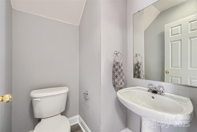 6335 Ziegler Ln, Charlotte, NC 28269 - bathroom featuring toilet, baseboards, and a sink