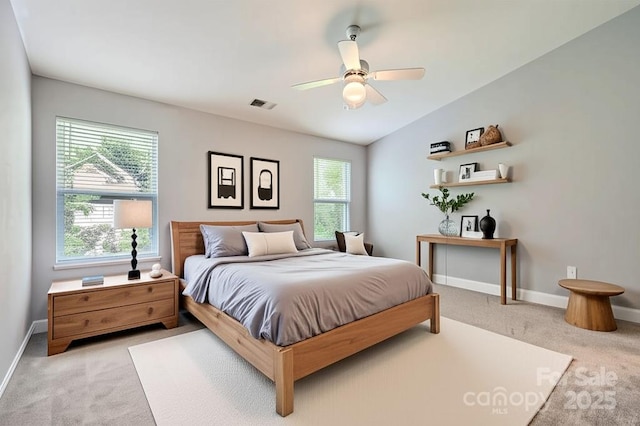 6335 Ziegler Ln, Charlotte, NC 28269 - bedroom featuring light carpet, multiple windows, baseboards, ceiling fan, and vaulted ceiling