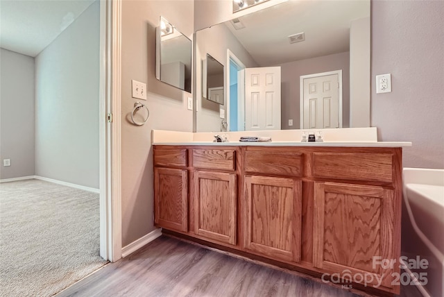 6335 Ziegler Ln, Charlotte, NC 28269 - full bathroom with double vanity, wood finished floors, and baseboards