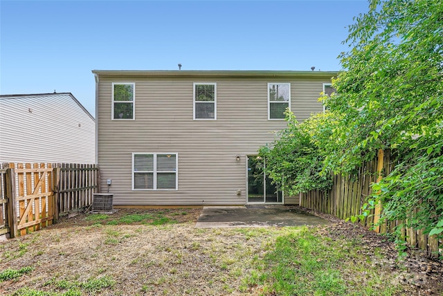 6335 Ziegler Ln, Charlotte, NC 28269 - back of property with a fenced backyard, a patio, and central air condition unit