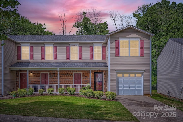 6335 Ziegler Ln, Charlotte, NC 28269 - traditional home with an attached garage, concrete driveway, covered porch, a lawn, and roof with shingles