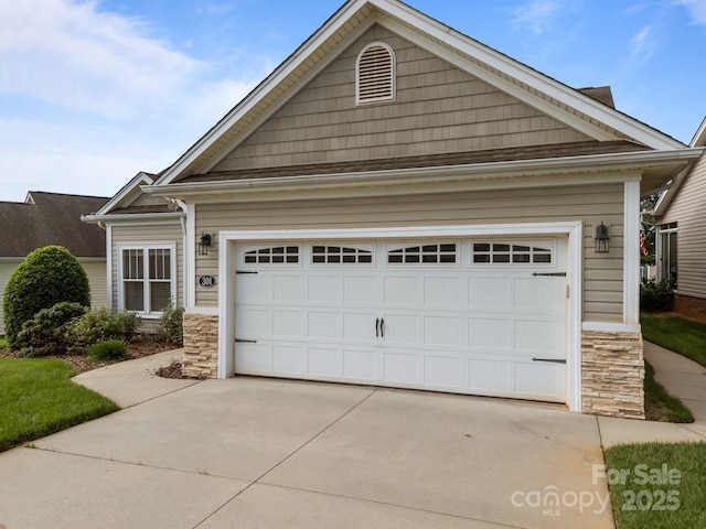 301 Garner Dr, Salisbury, NC 28146 - view of front of house with stone siding, concrete driveway, and an attached garage