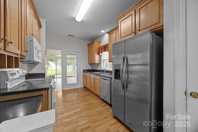 301 Garner Dr, Salisbury, NC 28146 - kitchen with stainless steel appliances, a sink, dark countertops, and light wood finished floors