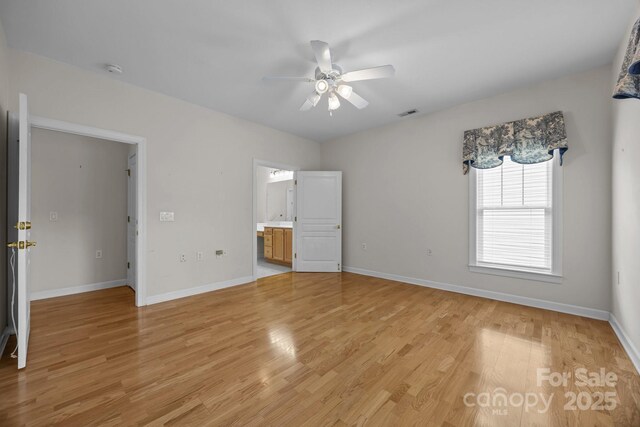 301 Garner Dr, Salisbury, NC 28146 - unfurnished bedroom featuring light wood-style floors, baseboards, ensuite bath, and ceiling fan