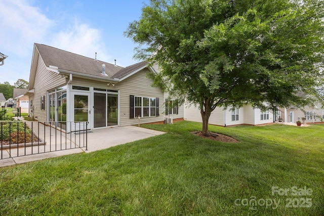301 Garner Dr, Salisbury, NC 28146 - back of house featuring a patio area, a lawn, and a shingled roof