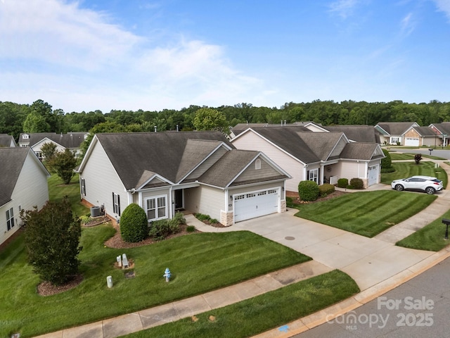 301 Garner Dr, Salisbury, NC 28146 - view of front of house with a garage, concrete driveway, a front lawn, and central AC