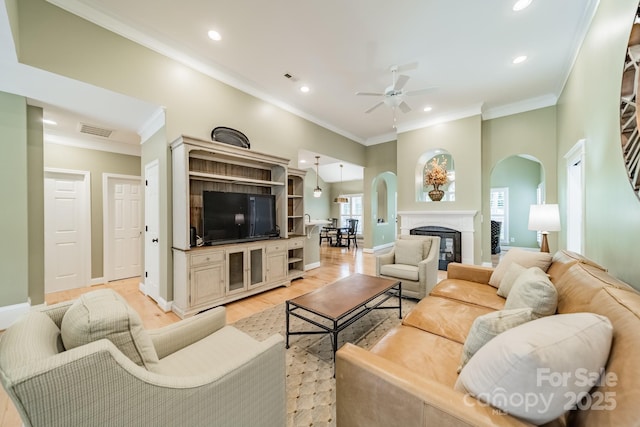 12039 Lawings Corner Dr, Huntersville, NC 28078 - living area with ceiling fan, arched walkways, crown molding, recessed lighting, and light wood-style flooring