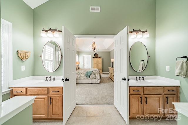12039 Lawings Corner Dr, Huntersville, NC 28078 - ensuite bathroom with a chandelier, tile patterned floors, and two vanities
