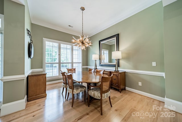 12039 Lawings Corner Dr, Huntersville, NC 28078 - dining space featuring a chandelier, ornamental molding, light wood-style floors, and baseboards