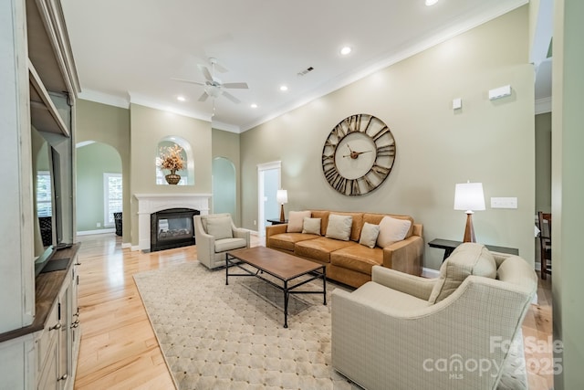 12039 Lawings Corner Dr, Huntersville, NC 28078 - living room with a ceiling fan, arched walkways, crown molding, light wood-style flooring, and recessed lighting