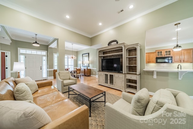 12039 Lawings Corner Dr, Huntersville, NC 28078 - living area featuring light wood-type flooring, recessed lighting, crown molding, baseboards, and a chandelier