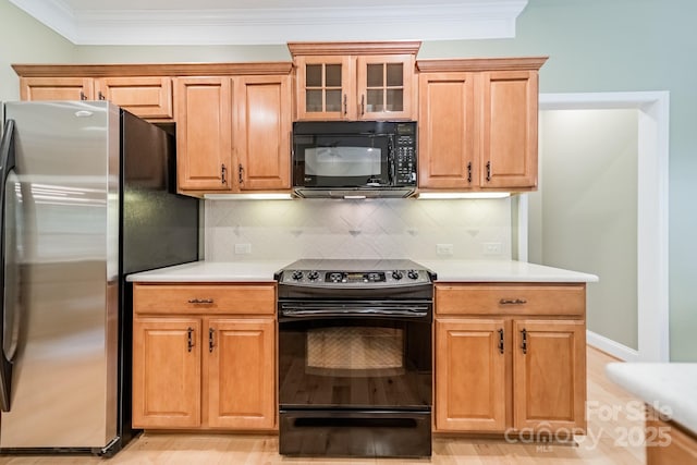 12039 Lawings Corner Dr, Huntersville, NC 28078 - kitchen featuring black appliances, light countertops, crown molding, glass insert cabinets, and decorative backsplash