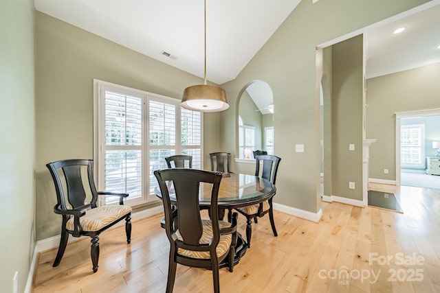 12039 Lawings Corner Dr, Huntersville, NC 28078 - dining room featuring lofted ceiling, light wood-style floors, baseboards, arched walkways, and recessed lighting