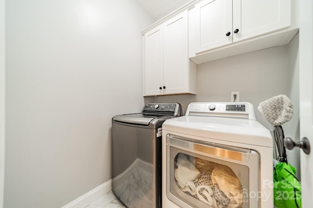 12039 Lawings Corner Dr, Huntersville, NC 28078 - washroom with washing machine and dryer, cabinet space, baseboards, and light marble finish flooring