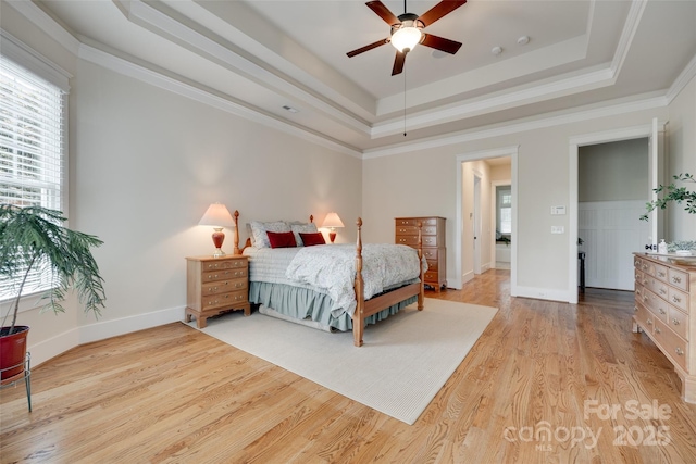 18311 Rosapenny Rd, Charlotte, NC 28278 - bedroom featuring wood finished floors, a tray ceiling, baseboards, crown molding, and a ceiling fan