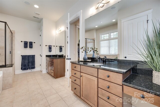 18311 Rosapenny Rd, Charlotte, NC 28278 - bathroom with tile patterned floors, two vanities, recessed lighting, tiled shower, and baseboards