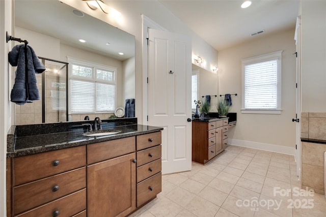 18311 Rosapenny Rd, Charlotte, NC 28278 - bathroom featuring tile patterned floors, two vanities, a stall shower, baseboards, and recessed lighting