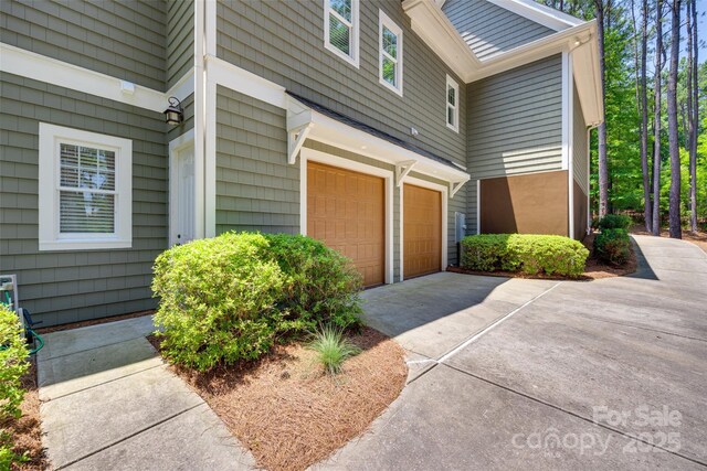 18311 Rosapenny Rd, Charlotte, NC 28278 - view of property exterior with an attached garage and driveway