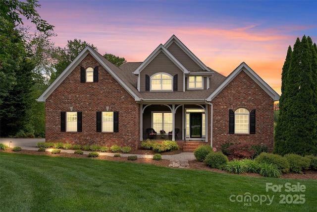 230 Fairway Falls Rd, Mills River, NC 28759 - traditional home with a porch, a yard, and brick siding
