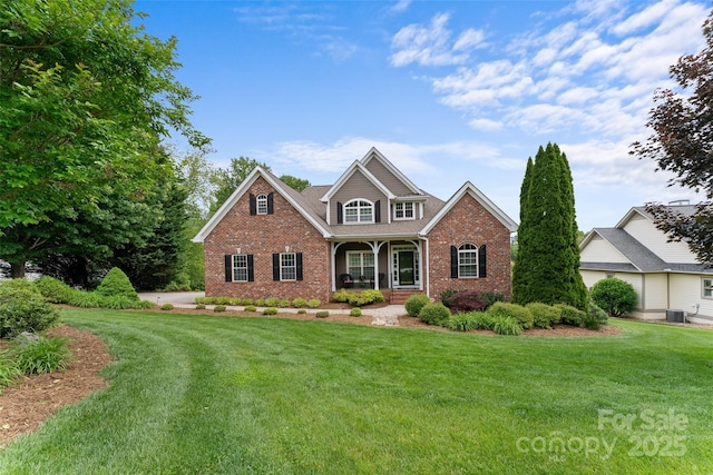 230 Fairway Falls Rd, Mills River, NC 28759 - traditional home featuring brick siding, a front lawn, and a porch