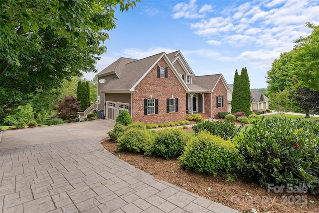 230 Fairway Falls Rd, Mills River, NC 28759 - traditional home with brick siding, a garage, driveway, and roof with shingles