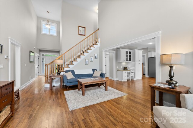 230 Fairway Falls Rd, Mills River, NC 28759 - living area featuring a high ceiling, stairs, wood finished floors, and baseboards