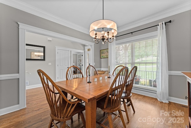 230 Fairway Falls Rd, Mills River, NC 28759 - dining area with a chandelier, wood finished floors, crown molding, and baseboards