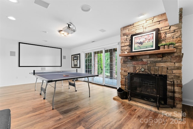 230 Fairway Falls Rd, Mills River, NC 28759 - rec room featuring wood finished floors, a stone fireplace, and recessed lighting