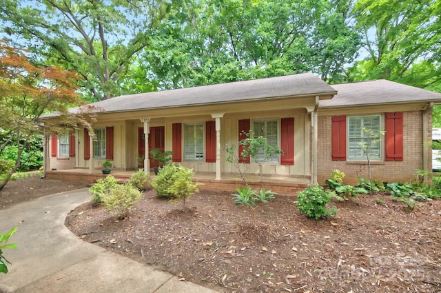 3430 Rea Rd, Charlotte, NC 28226 - ranch-style house featuring a porch, brick siding, and a shingled roof