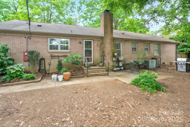 3430 Rea Rd, Charlotte, NC 28226 - rear view of property featuring brick siding, a patio, a chimney, and a shingled roof