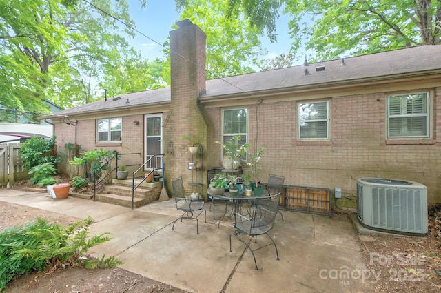 3430 Rea Rd, Charlotte, NC 28226 - back of house featuring central AC unit, a chimney, brick siding, and a patio area