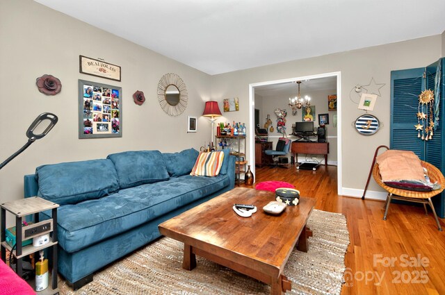 3430 Rea Rd, Charlotte, NC 28226 - living area with a chandelier, a desk, wood finished floors, and baseboards
