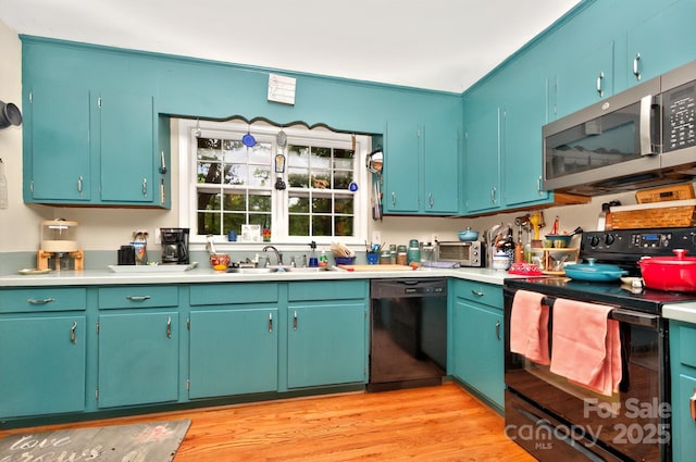 3430 Rea Rd, Charlotte, NC 28226 - kitchen with black appliances, a sink, light countertops, and light wood finished floors