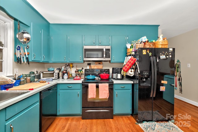 3430 Rea Rd, Charlotte, NC 28226 - kitchen with black appliances, light wood finished floors, light countertops, and baseboards