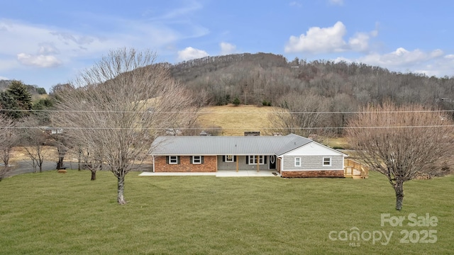 276 Bob Mcneill Rd, West Jefferson, NC 28694 - back of house with a lawn, a patio area, brick siding, and a mountain view