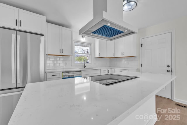 276 Bob Mcneill Rd, West Jefferson, NC 28694 - kitchen featuring exhaust hood, appliances with stainless steel finishes, a sink, white cabinets, and light stone countertops