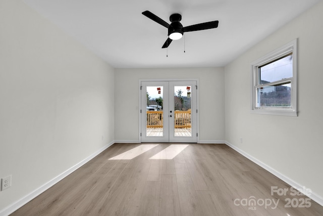 276 Bob Mcneill Rd, West Jefferson, NC 28694 - empty room with french doors, wood finished floors, plenty of natural light, and baseboards