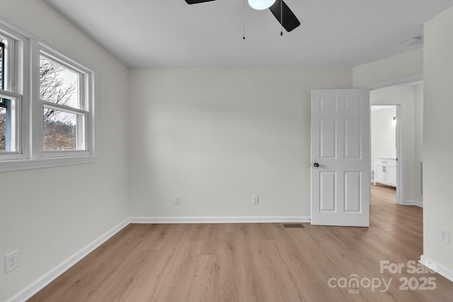 276 Bob Mcneill Rd, West Jefferson, NC 28694 - unfurnished bedroom with light wood-style flooring, baseboards, and ceiling fan