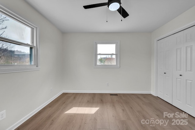 276 Bob Mcneill Rd, West Jefferson, NC 28694 - unfurnished bedroom with wood finished floors, a closet, baseboards, and a ceiling fan