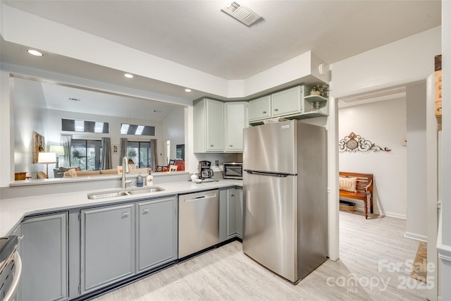 115 Pine Grove Cir, Clover, SC 29710 - kitchen featuring stainless steel appliances, a sink, light wood-type flooring, recessed lighting, and light countertops