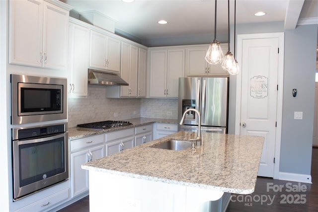 745 Garrett Green Way, Fort Mill, SC 29715 - kitchen with appliances with stainless steel finishes, under cabinet range hood, a sink, backsplash, and light stone countertops