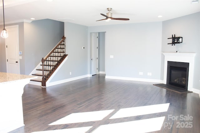 745 Garrett Green Way, Fort Mill, SC 29715 - unfurnished living room with a ceiling fan, recessed lighting, a glass covered fireplace, dark wood-style flooring, and stairs