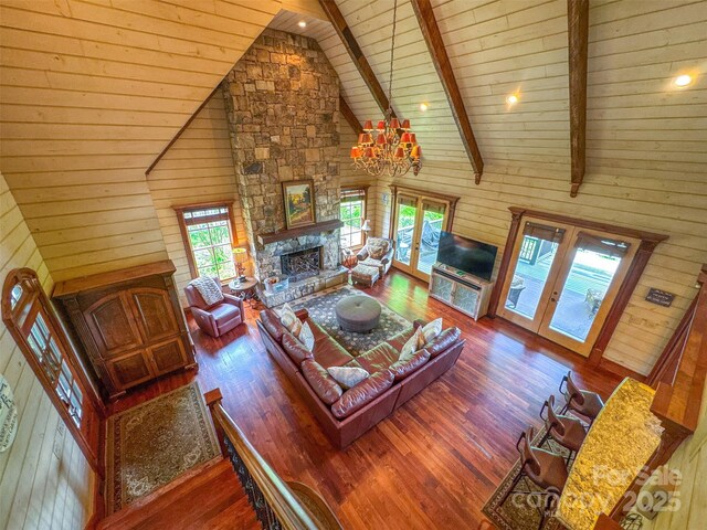 414 Trails End Rd, Bryson City, NC 28713 - living area with wooden ceiling, high vaulted ceiling, healthy amount of natural light, wood walls, and a stone fireplace