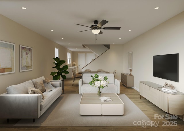 living area with wood finished floors, ceiling fan, recessed lighting, and baseboards
