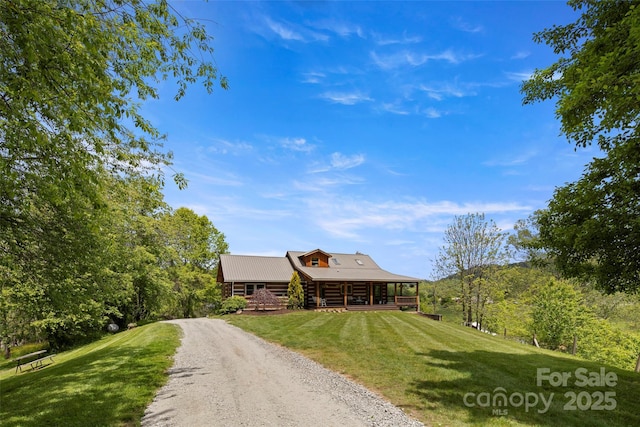 225 Ford Rd, Waynesville, NC 28786 - cabin with log siding, a front yard, dirt driveway, and a porch