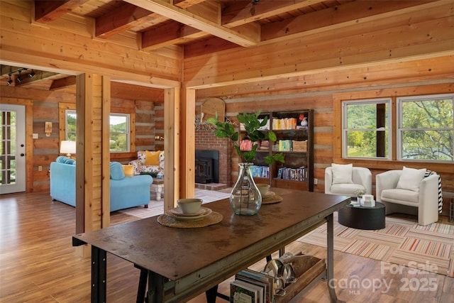 225 Ford Rd, Waynesville, NC 28786 - dining room featuring wooden walls, beam ceiling, wood ceiling, and light wood finished floors