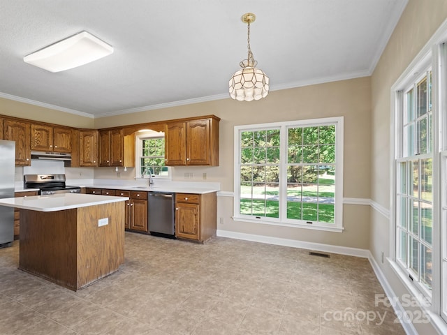 kitchen featuring stainless steel appliances, under cabinet range hood, a sink, brown cabinetry, and light countertops